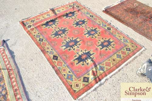 A Caucasian pattern rug, with stylised motifs and