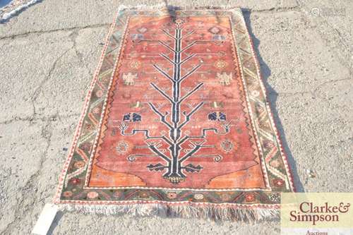 An Eastern wool rug, stylised tree of life pattern