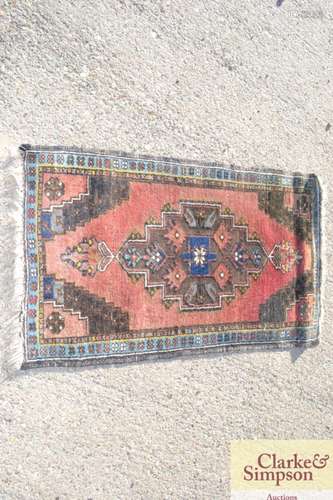 A small Eastern rug, having central lozenge motif