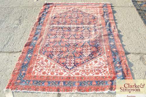 An Eastern wool rug, having central stylised flora