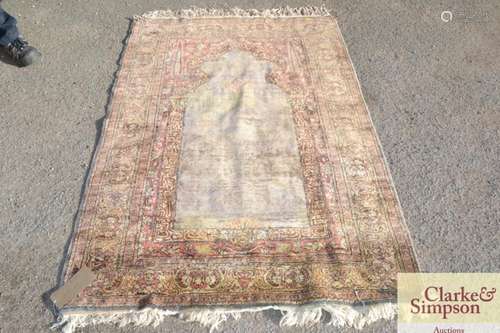 An Eastern wool prayer rug, having central Mihrab