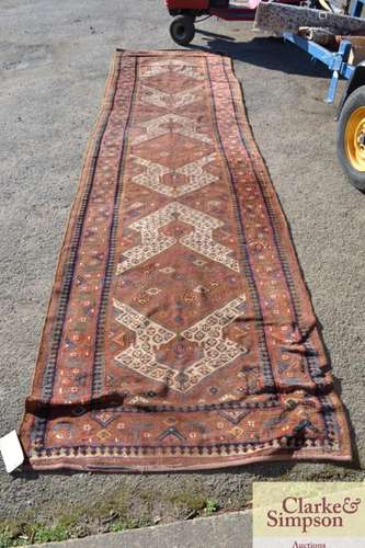 An Eastern wool runner, decorated central lozenge