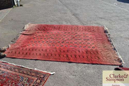 A small Bokhara carpet, of traditional pattern on