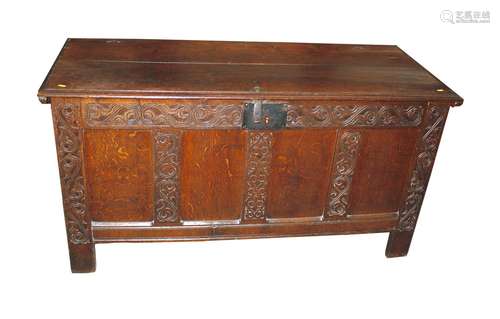 An antique oak coffer, enclosed by a plain panel lid, iron h...