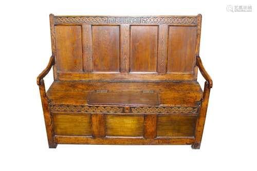 An antique oak settle,dated 1681 having foliate scroll decor...