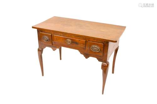 An antique oak low boy,with over hanging top above three dra...