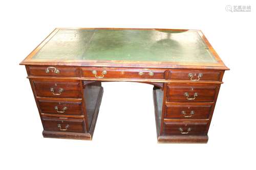 An Edwardian mahoganypedestal writing desk,the leather inset...