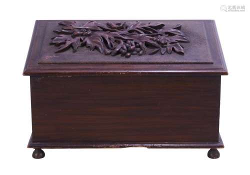 AN AUSTRALIAN CARVED AND STAINED HARDWOOD FIREWOOD BOX CIRCA...