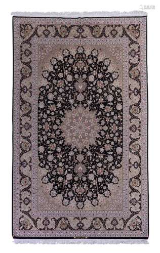 A FINE CENTRAL PERSIAN ISFAHAN SILK AND KORK WOOL CARPET SIG...