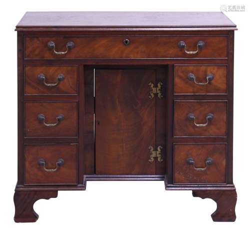 A GEORGE III AND LATER MAHOGANY KNEEHOLE DESK OF SMALL PROPO...