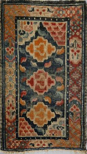 . A Tibetan rug with peonies Tibet, early 20th century