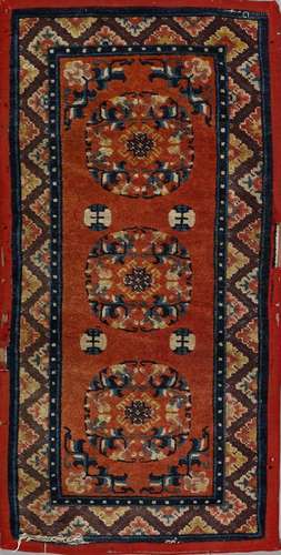 . A Tibetan rug decorated with chevron in the border