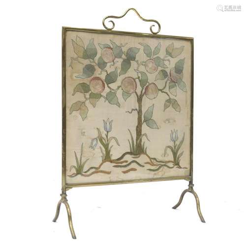 An Arts & Crafts brass framed firescreen