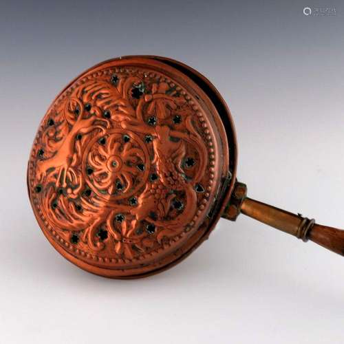 An Arts and Crafts embossed copper warmi