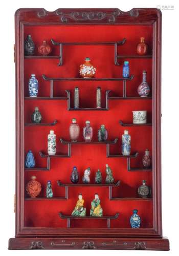 A cabinet with a collection of snuff bottles and curiosities...