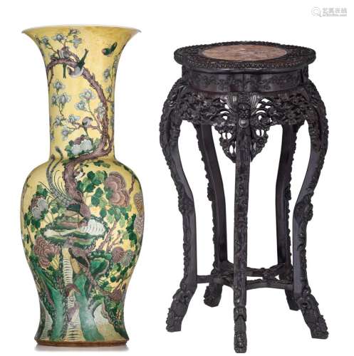 A Chinese famille jaune biscuit baluster vase, on a wooden b...