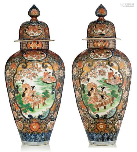 A monumental pair of Japanese Imari baluster vases and cover...