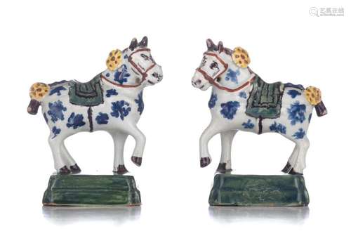 A charming pair of Dutch Delft polychrome miniature figures ...