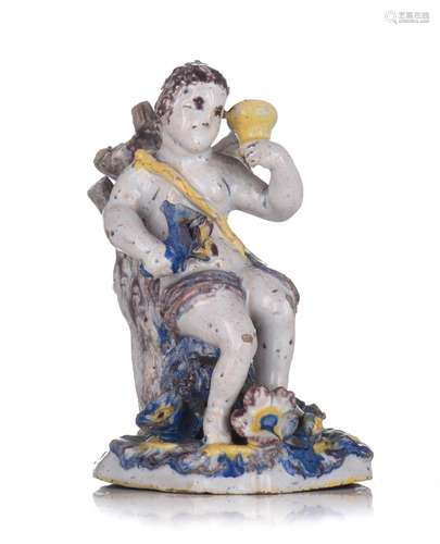 A Dutch Delft polychrome figure of a man holding flowers and...