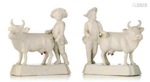 A pair of Delft white-glazed models of cows and cowherds, 18...