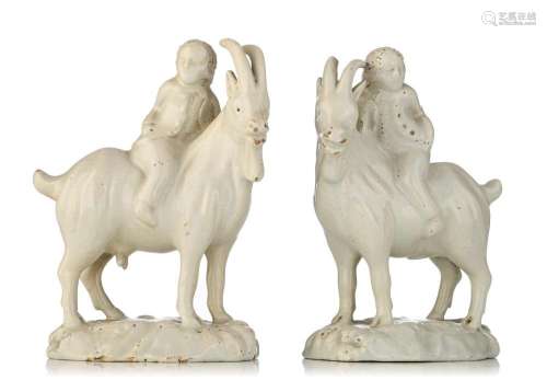 A pair of Dutch Delft white-glazed models of boys riding goa...