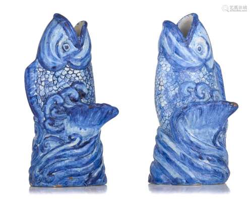 A pair of Delft style blue and white carp-shaped vases, mark...