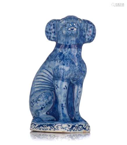 A Dutch Delft blue and white figure of a seated dog, 18thC, ...