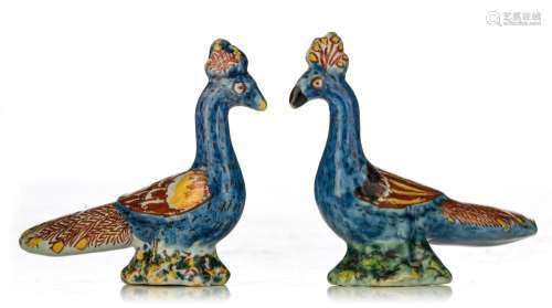 A charming pair of Dutch Delft polychrome figures of peacock...