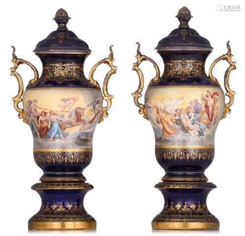 A pair of Viennese blue ground porcelain vases, with hand-pa...