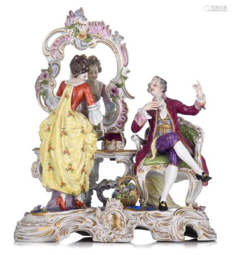 A Saxony porcelain group depicting a gallant couple in a Roc...