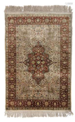 An Iranian Hereke floral decorated medallion rug, silk on si...