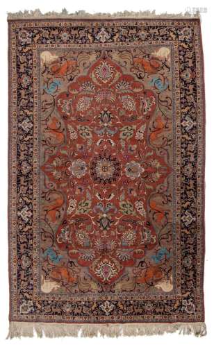 A Persian Ispahan woollen rug, decorated with lions and deer...