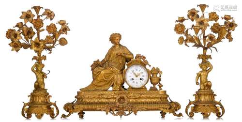 A large Neoclassical gilt bronze three-piece clock garniture...