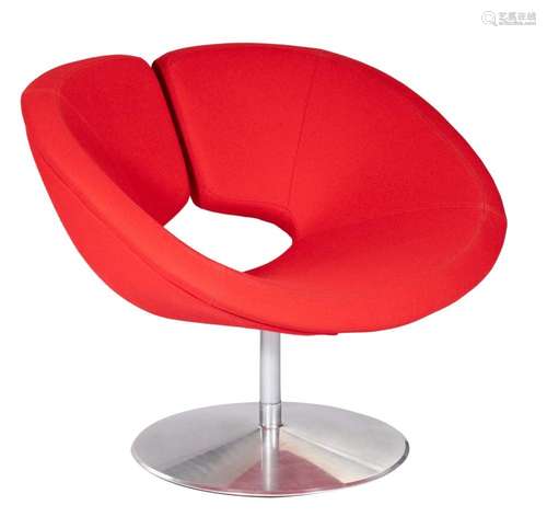 A red upholstered 'Apollo' chair, designed by Patric...