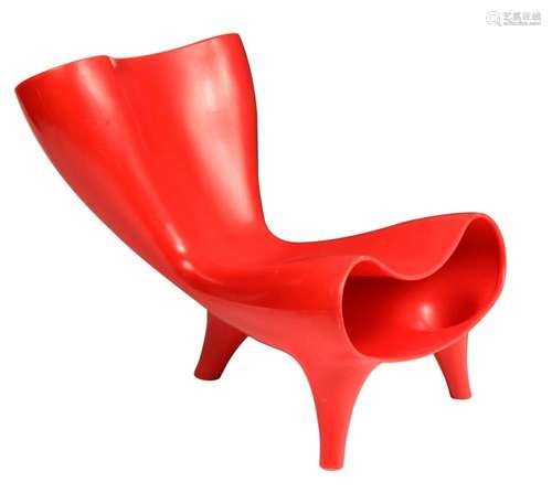 A red plastic 'Orgone' chair, designed by Mark Newso...