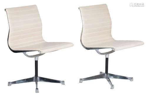 A pair of Eames 'EA105' swivel chairs, and white ...