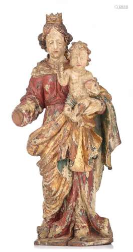 A polychrome and gilt painted oak sculpture of Madonna and C...