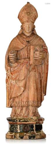 A limewood sculpture of a bishop, with a reliquary to the bo...