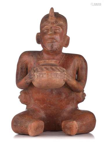 A 'warrior or shaman' figure holding a vessel, type ...