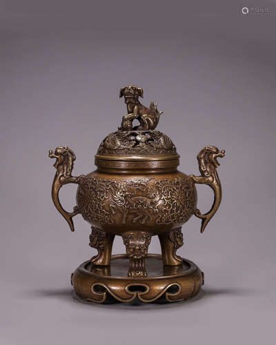 A hollowed out copper qilin incense burner