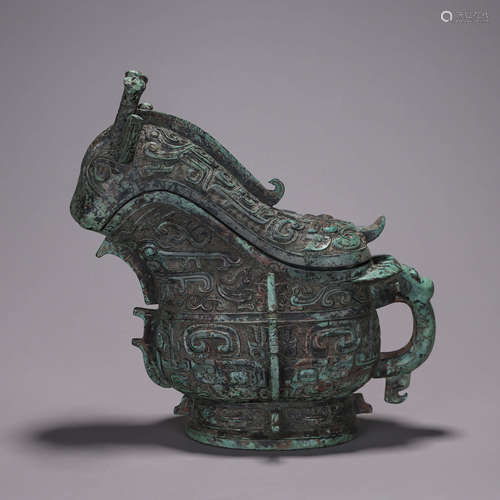 A taotie patterned bronze goat head pot