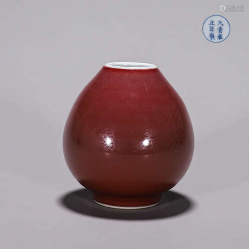 A red glazed porcelain water pot