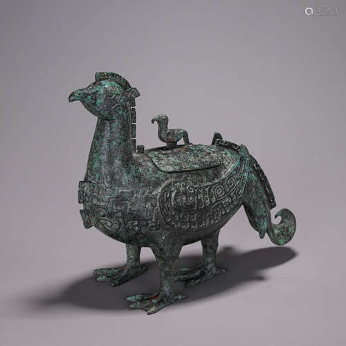 A taotie patterned bronze phoenix bird zun