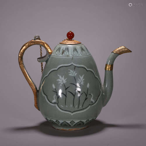 A gilt porcelain ewer