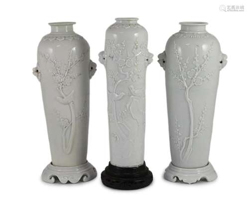 A near pair of Chinese blanc-de-chine sleeve vases with stan...