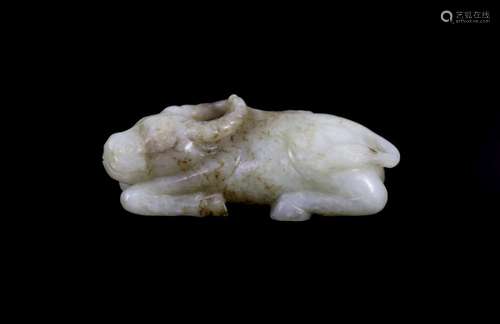 A Chinese Ming pale celadon and brown jade figure of a recum...