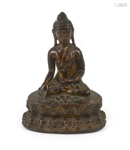 A small Tibetan gilt copper alloy seated figure of Buddha Sh...