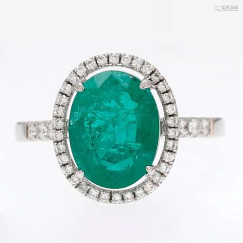 Emerald ring trimmed with diamonds.