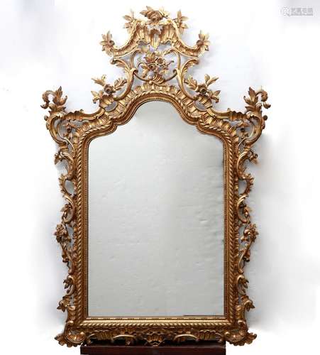 Roccoco-style mirror with frame in carved and gilded wood, e...