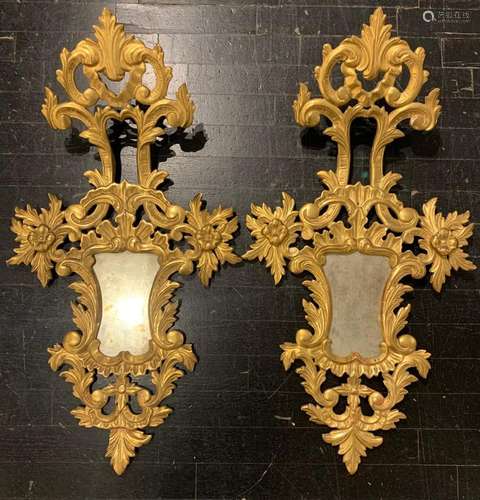 Pairof Rococo style ornamental mirrors in moulded and gilded...